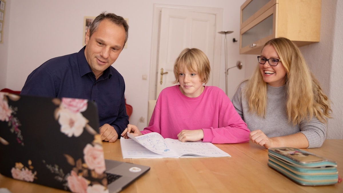 Parents and daugther learning together.